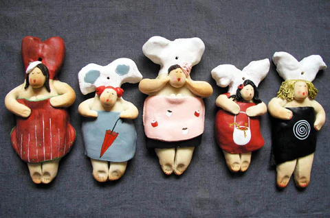 Dried dough angels side by side, in various poses