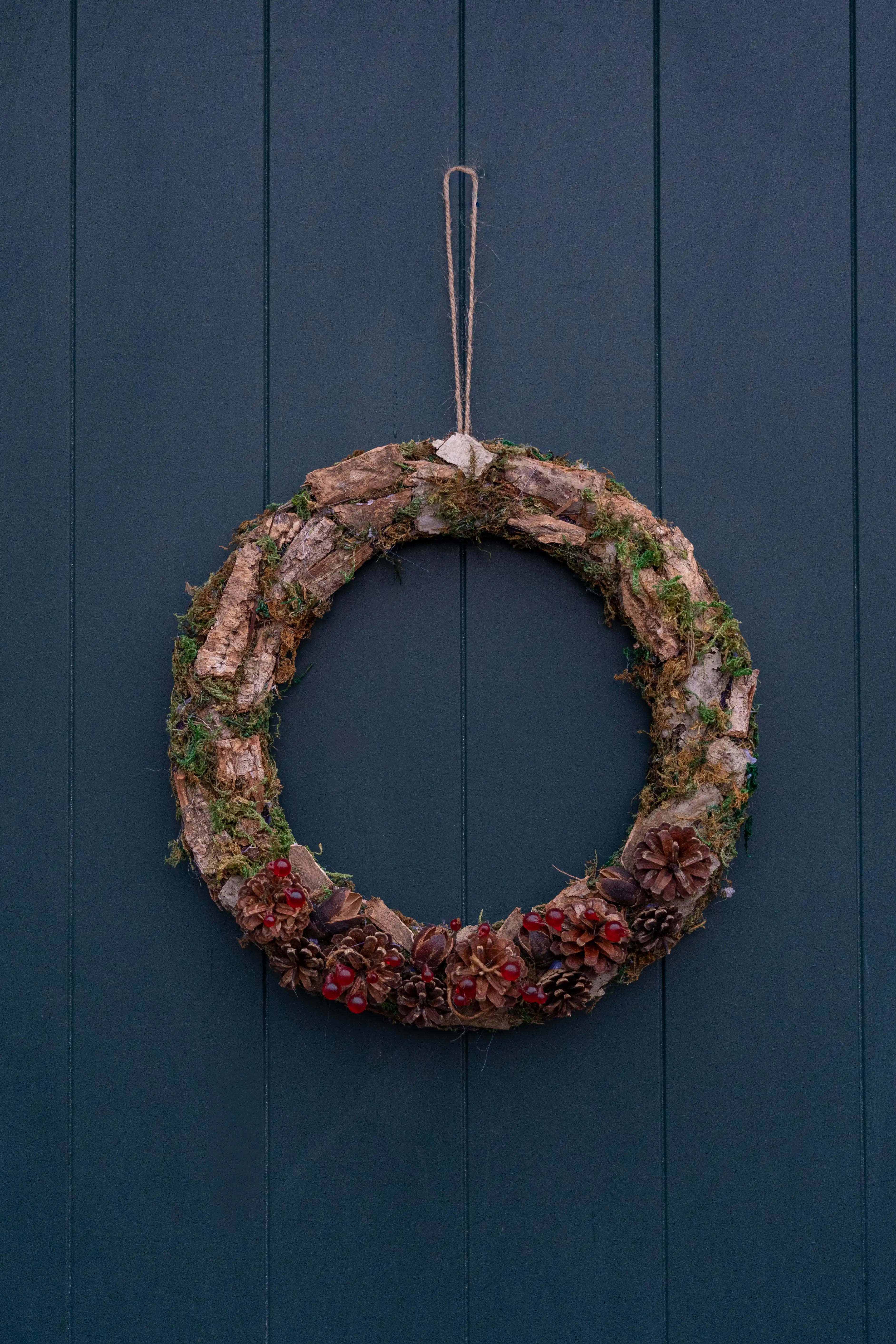 Homemade Christmas Decorations - Wreath made from household items, hung against a blue door